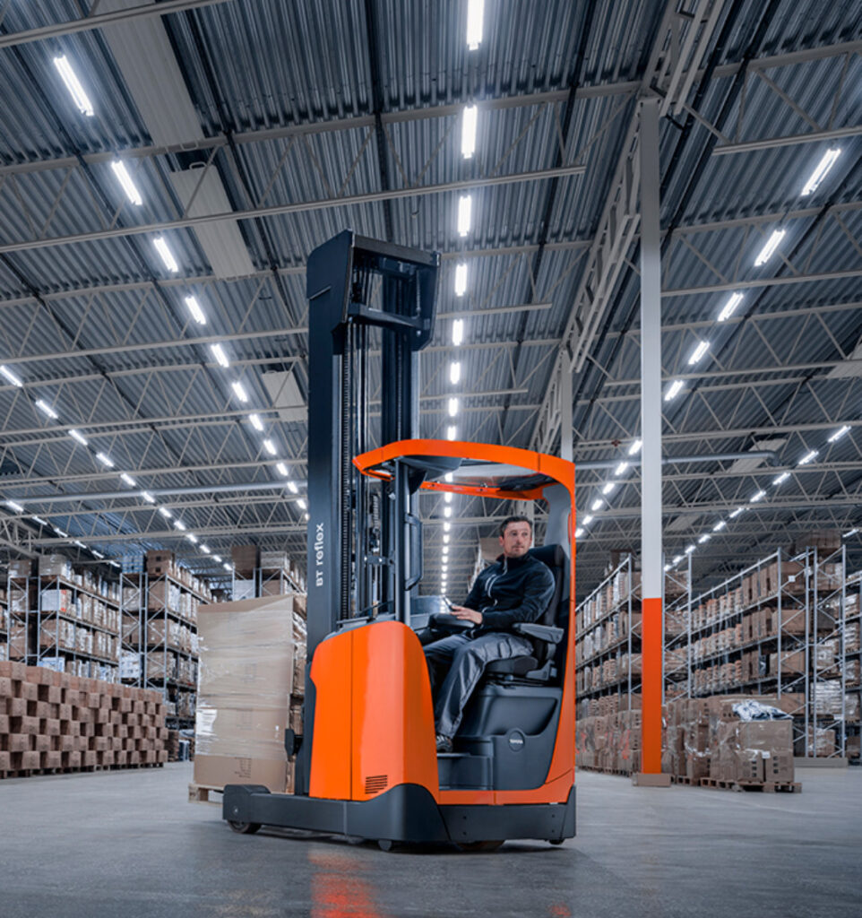 Employee moving boxes in warehouse